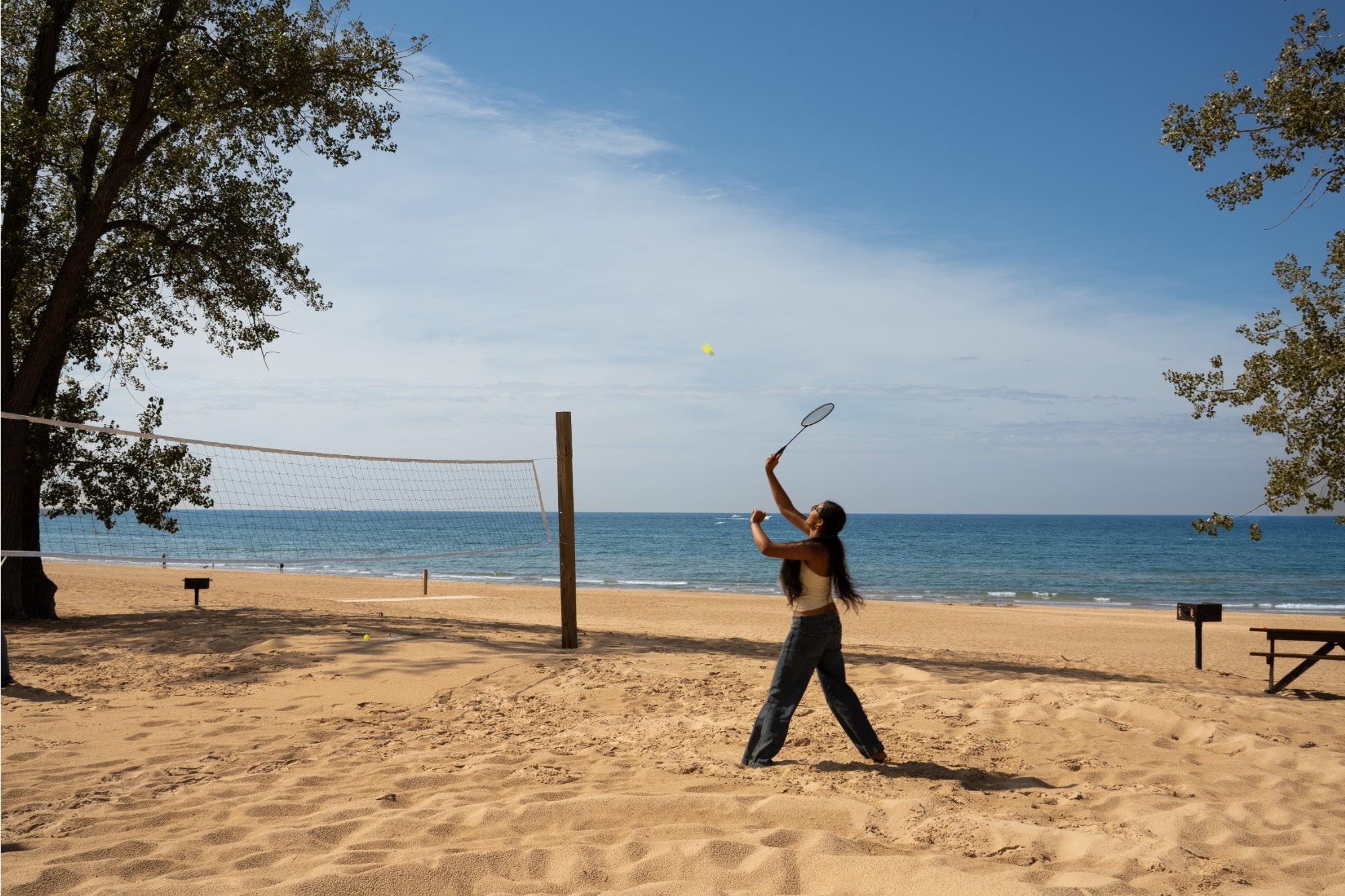 Girl playing badminton on the beach